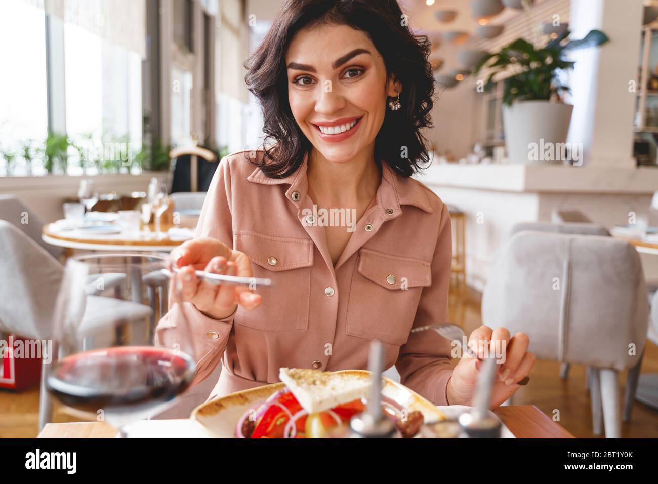 Beautiful young lady having lunch in cafe Stock Photo