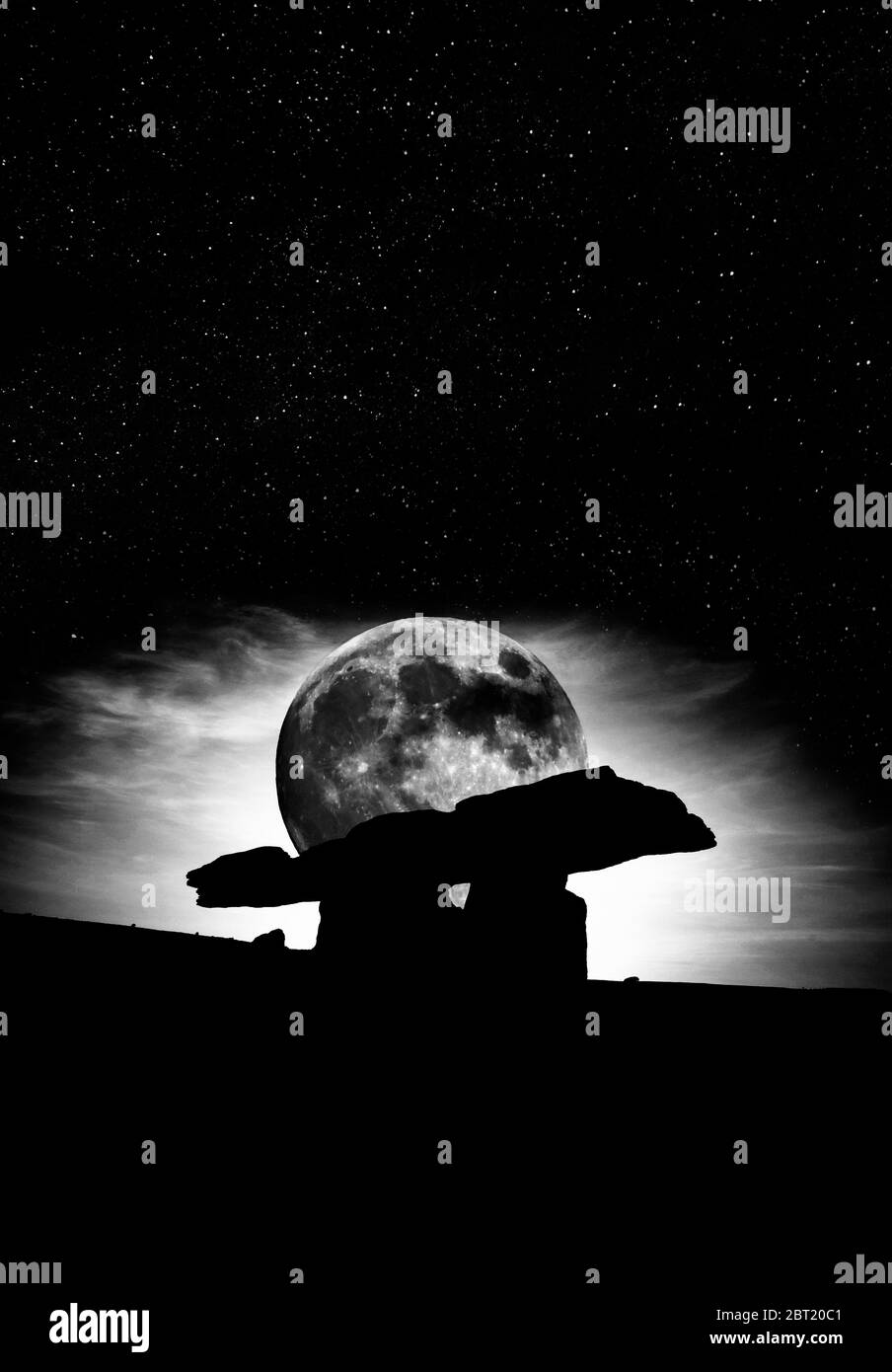 Silhouetted against a surrealistic super moon, the 6,000 year old Poulnabrone Dolmen, The Burren, County Clare, Ireland Stock Photo