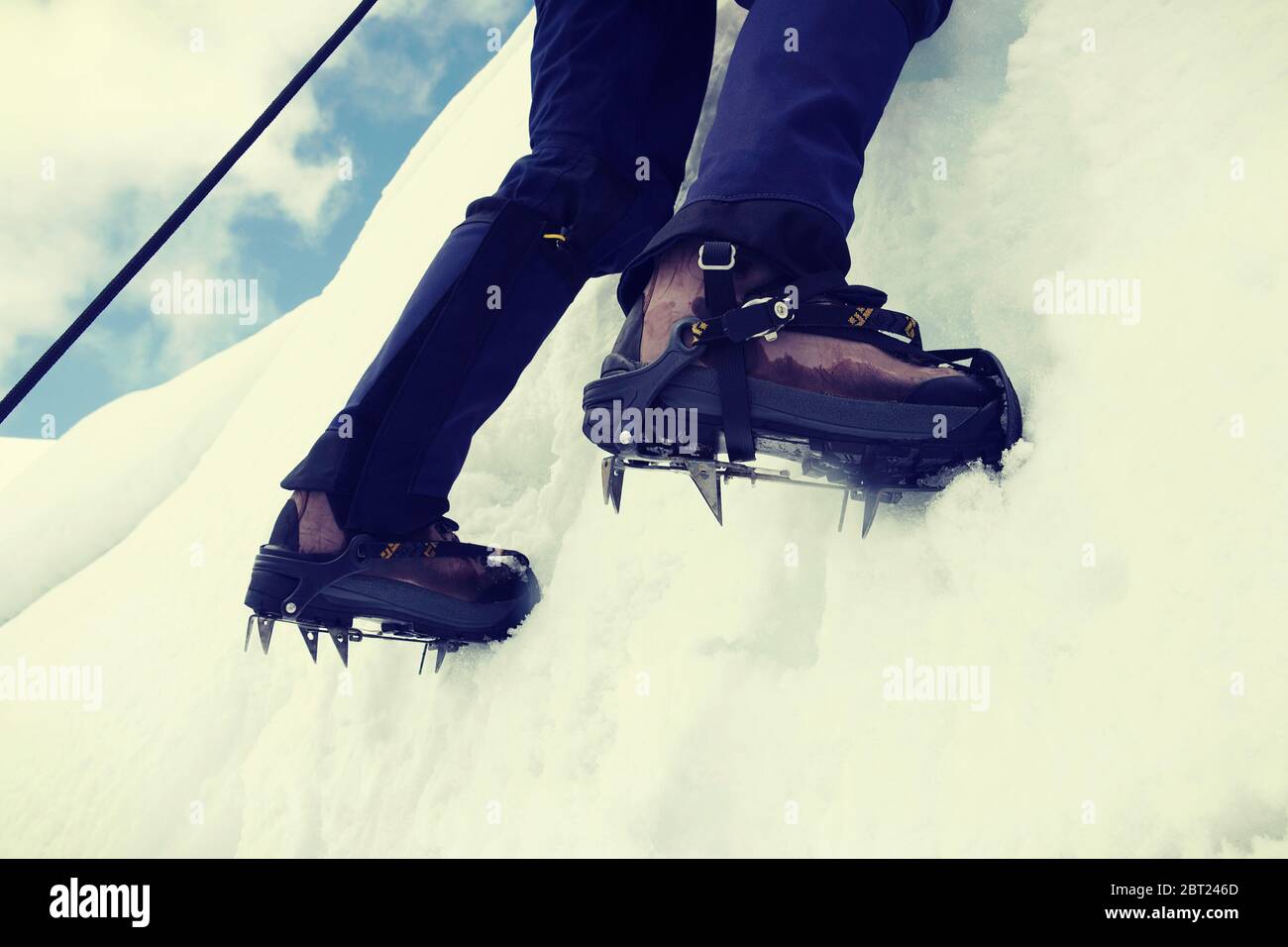 Close up of climber climbing ice mountain in mountainering  shoes Stock Photo