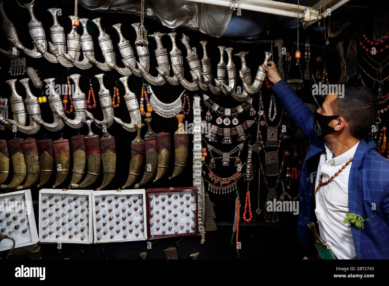 Sanaa, Yemen. 22nd May, 2020. A vendor of daggers waits for customers ...