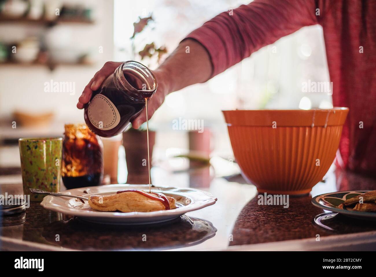 Father making pancakes for breakfast, USA Stock Photo