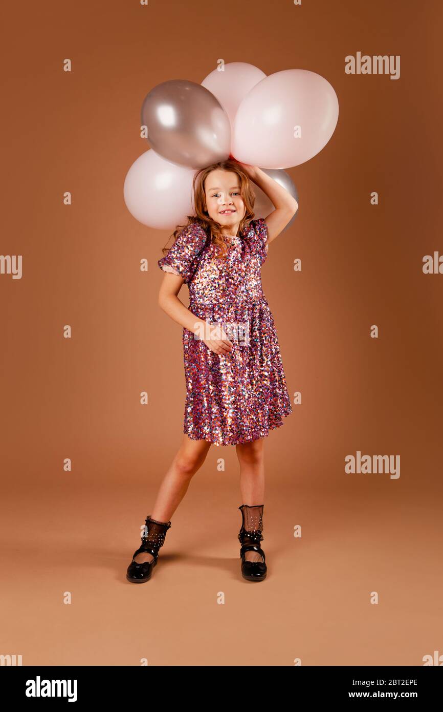 Holding a bunch of balloons hi-res stock photography and images - Alamy