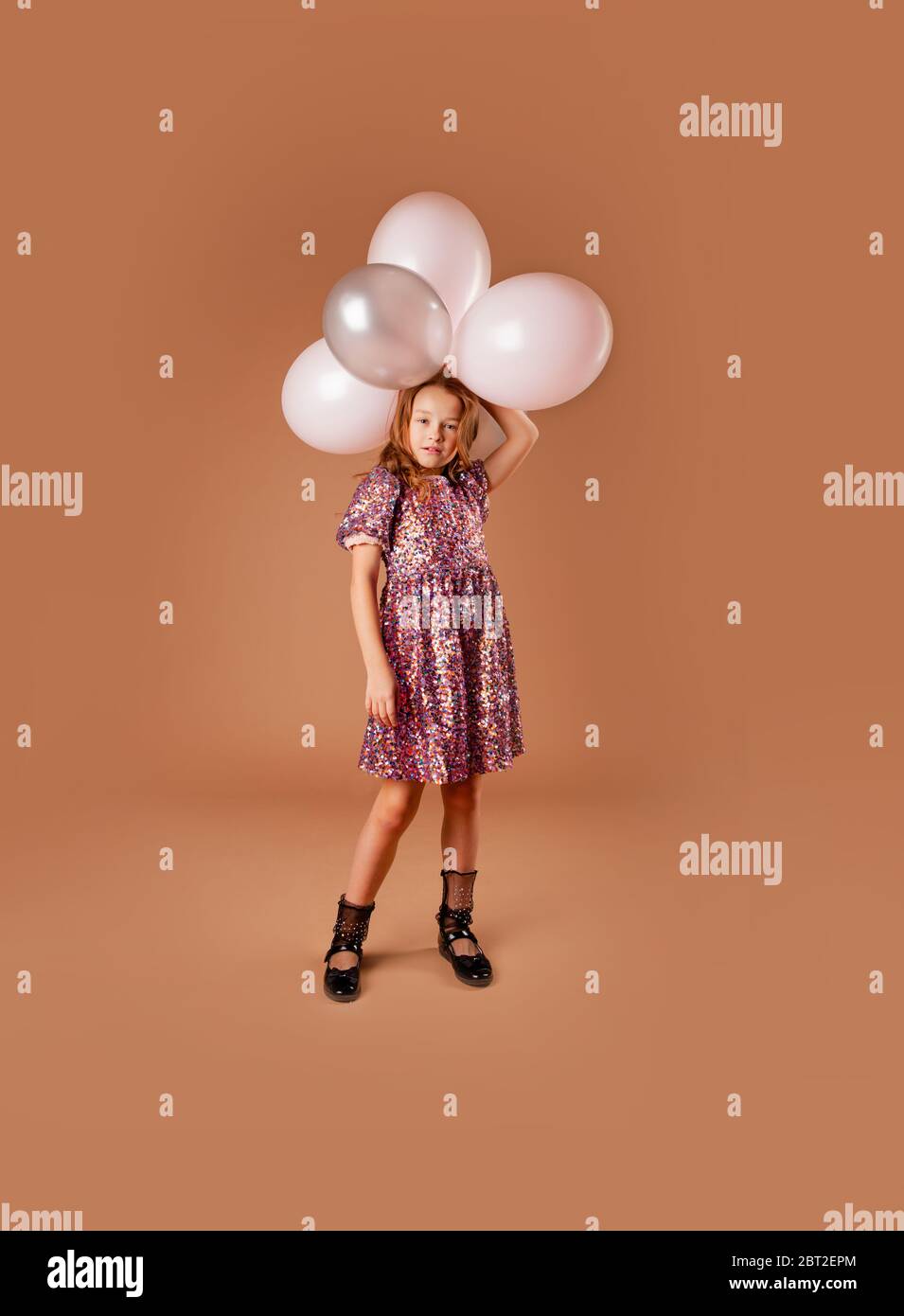 Holding a bunch of balloons hi-res stock photography and images - Alamy