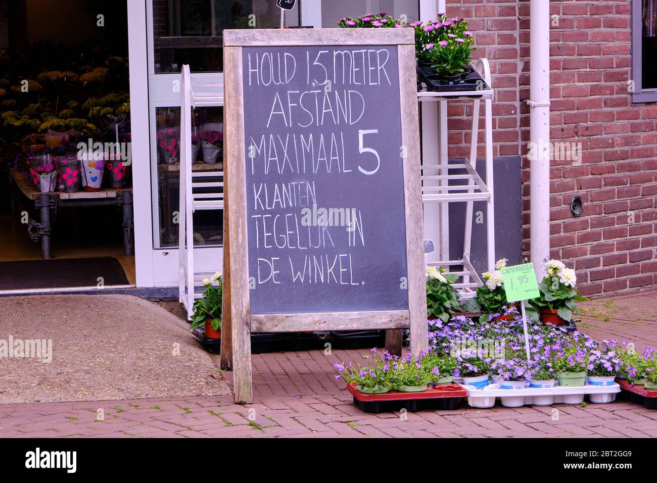 flower shop has a big sign outside with corona rules Stock Photo