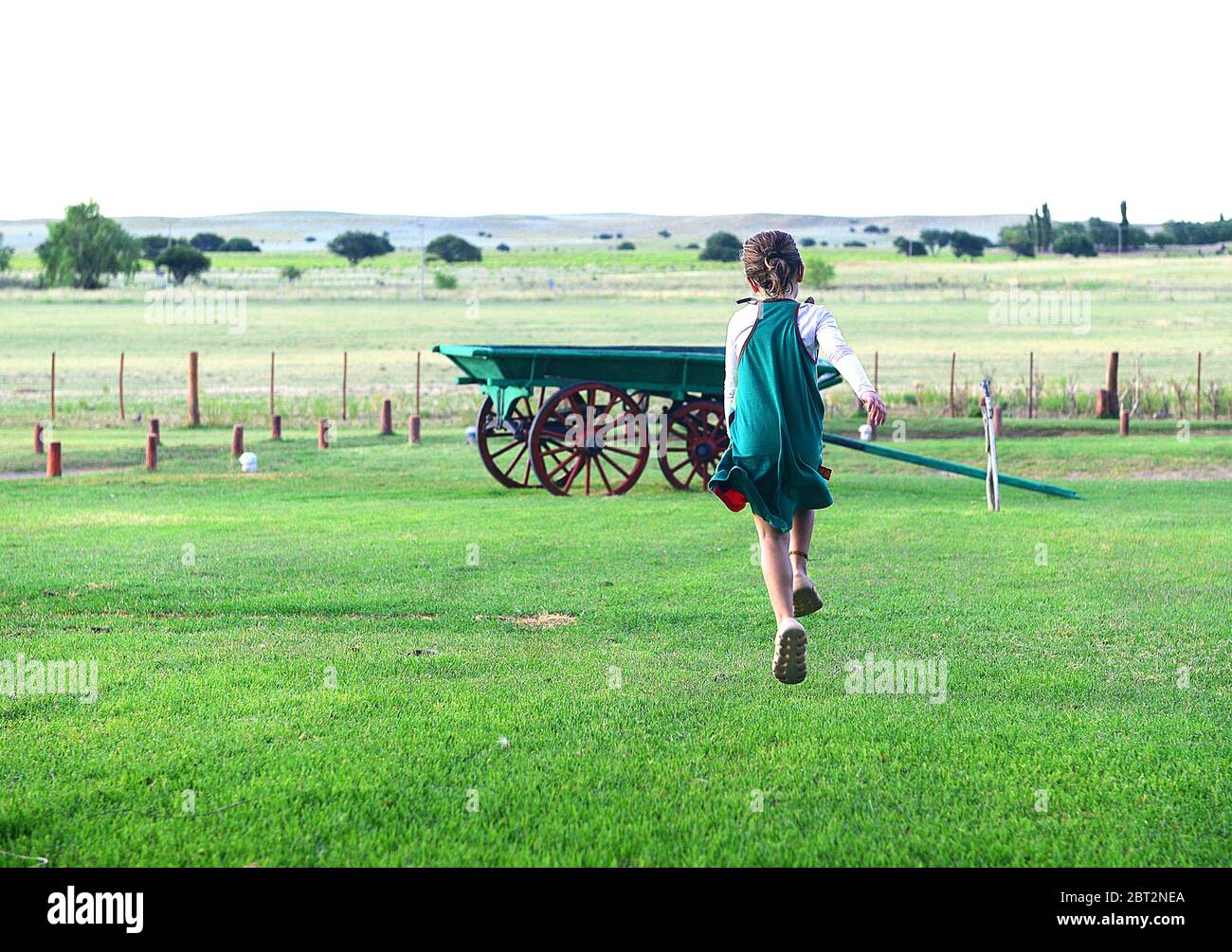 Girl running in a field, Argentina Stock Photo