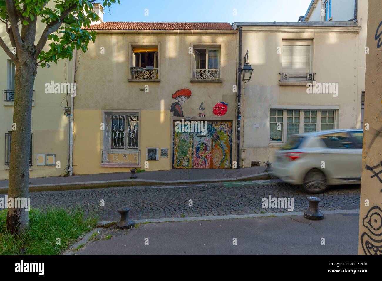Paris, France - May 17, 2020: General view of various graffitis painted on a small building, taken at the end of the day, Butte-aux-Cailles Stock Photo