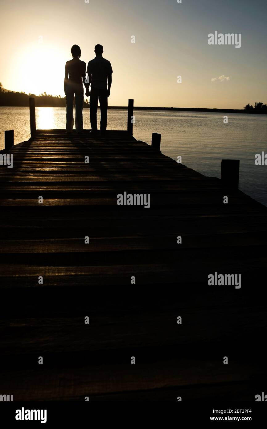 Man woman watching sunset over hi-res stock photography and images - Alamy
