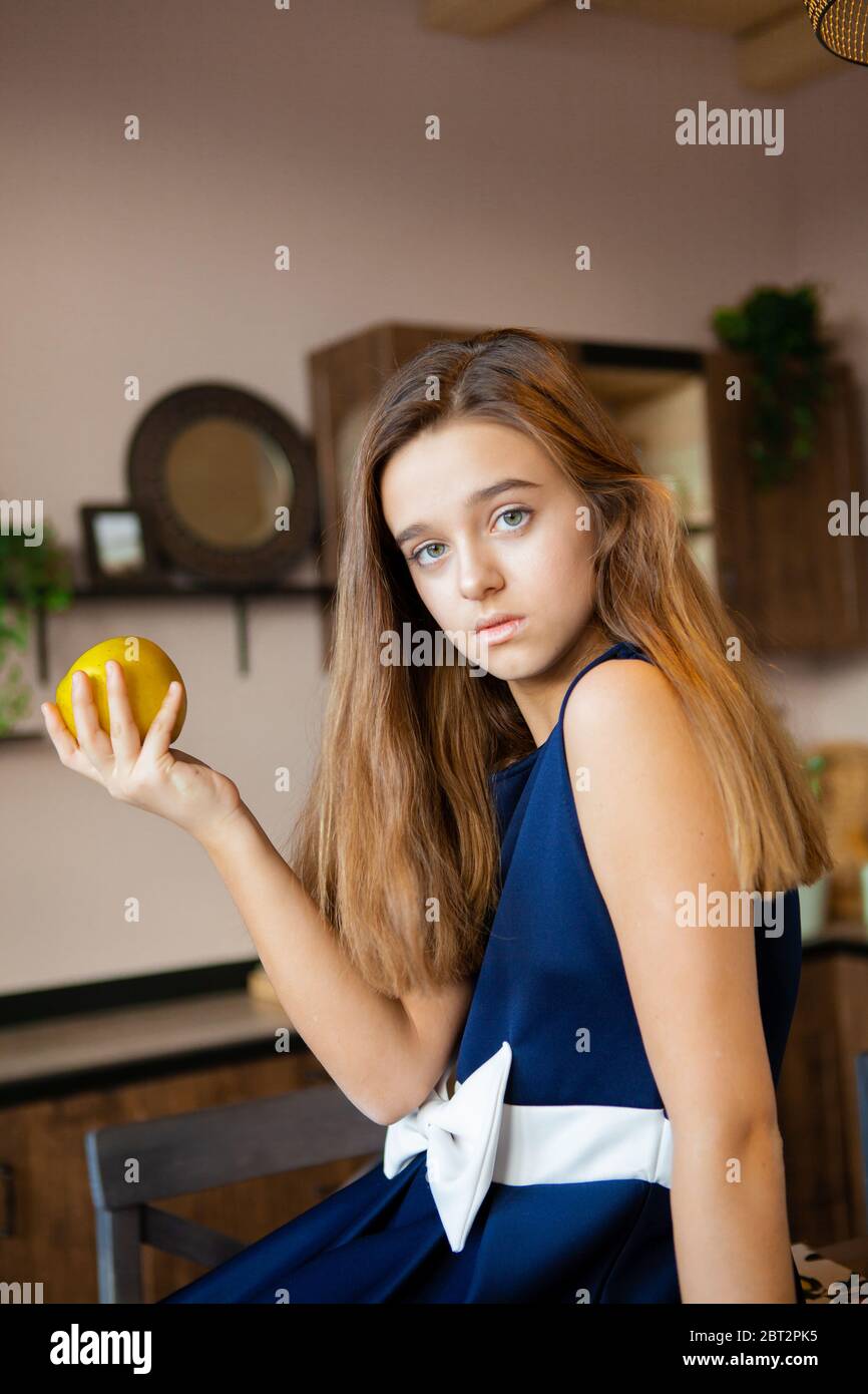 girl holds green sour apple Stock Photo