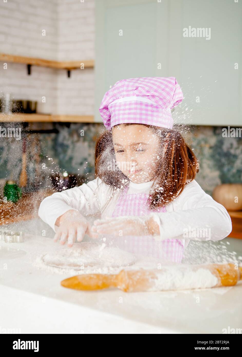 Girl in the kitchen kneads dough Stock Photo - Alamy