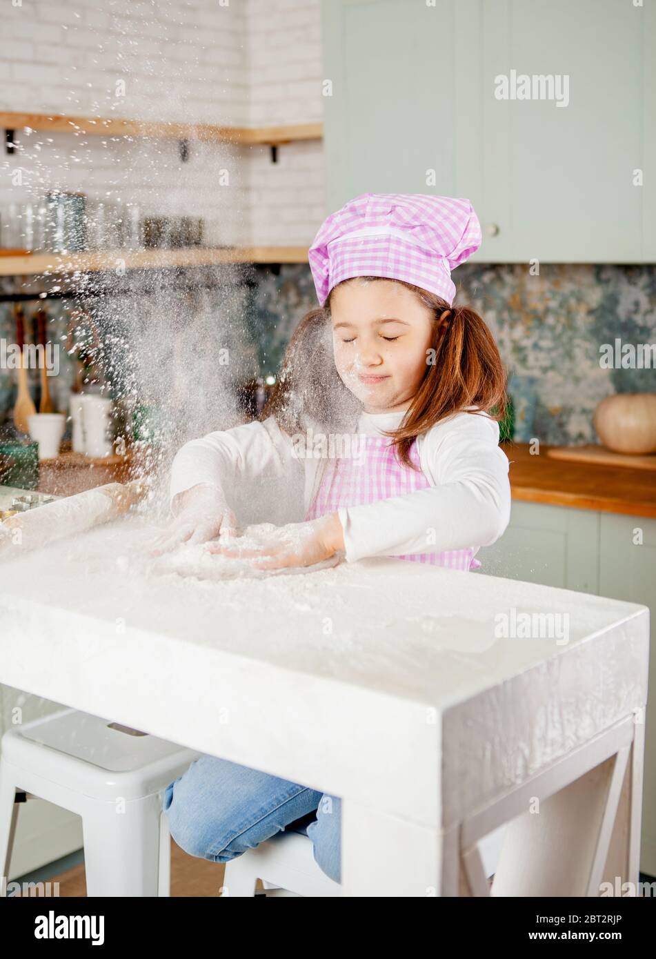 Girl In The Kitchen Kneads Gingerbread Dough Stock Photo Alamy