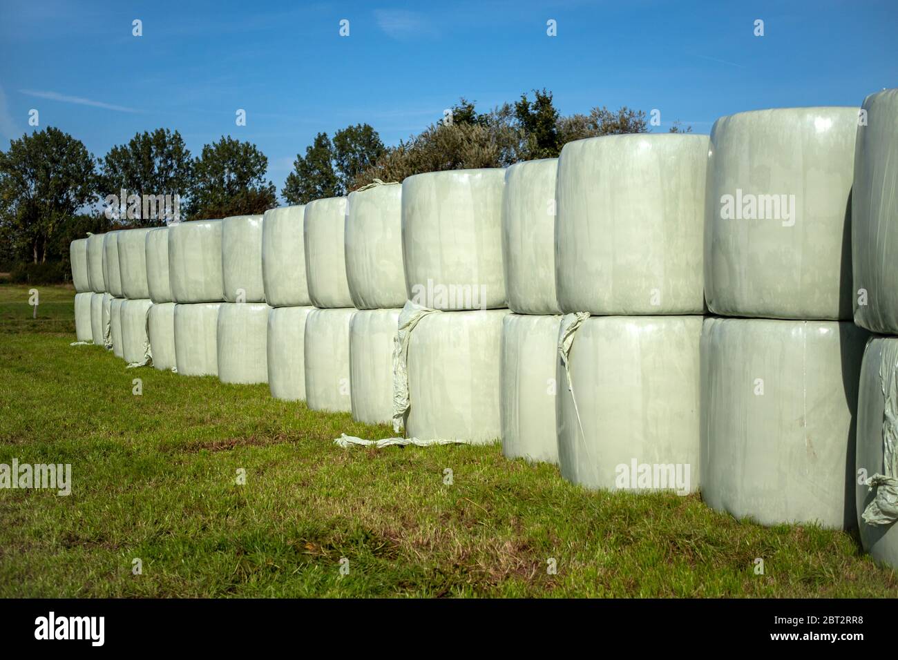 hay bales wrapped in foil and stacked on top of each other for storage