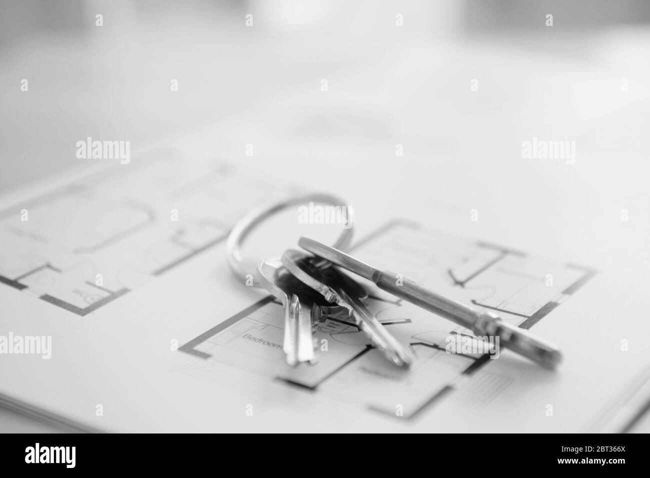 Black and White Photo of house keys on property floor plans Stock Photo