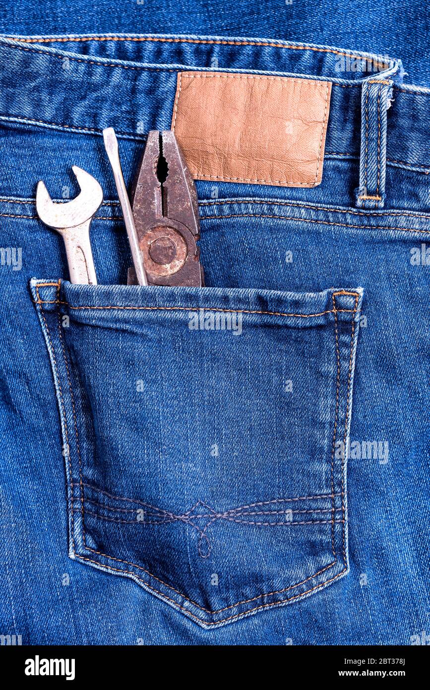 Close up of Jeans back pocket of classic blue denim pants with workman tool  - Wrench, Screwdriver and Pliers Stock Photo - Alamy