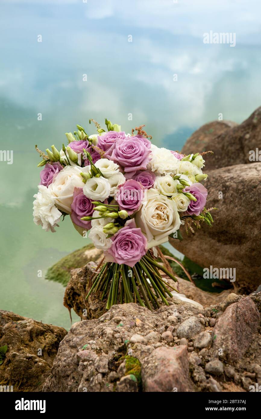 Wedding Bouquet Of Purple And White Roses On Stones Stock Photo Alamy