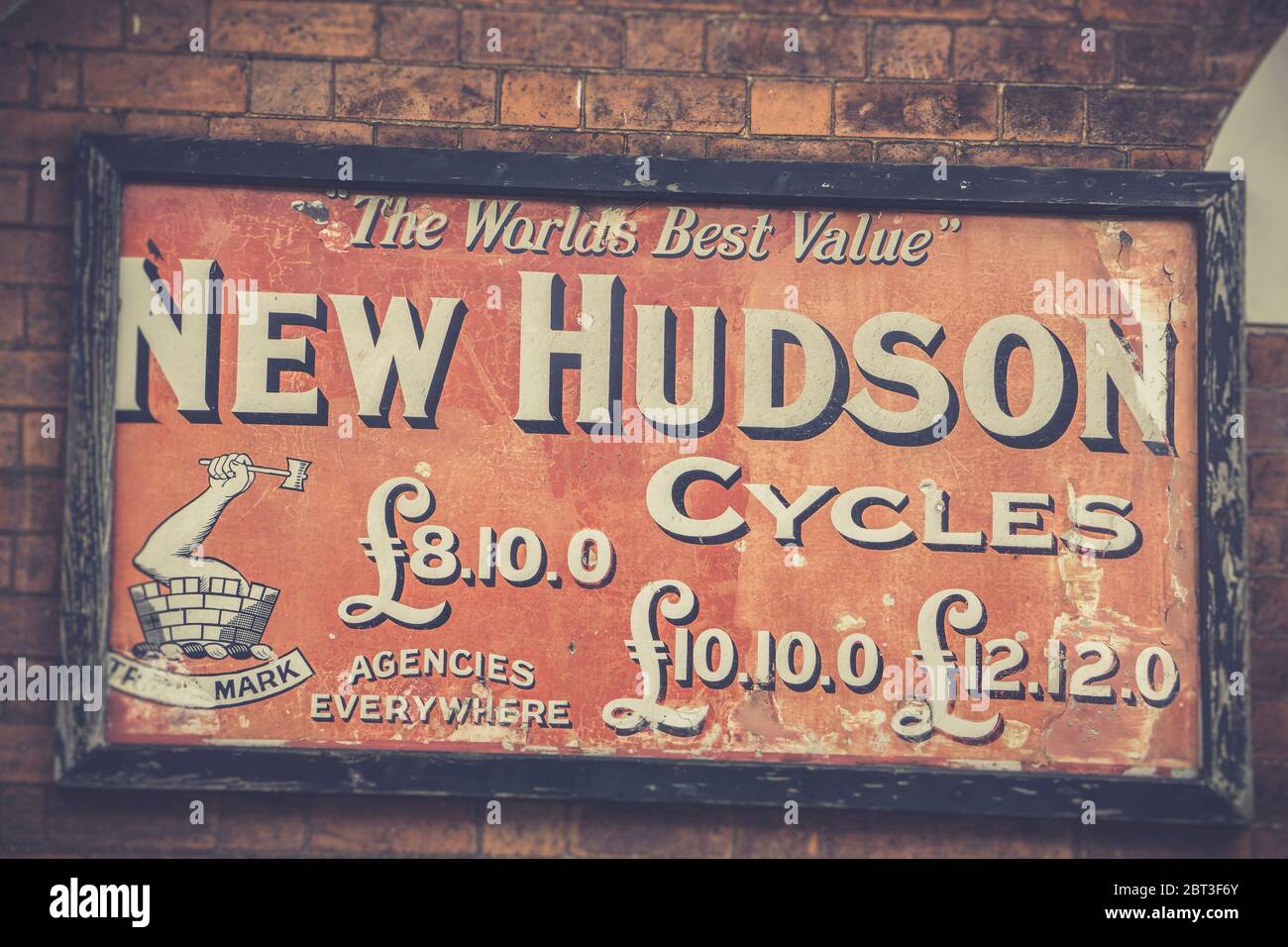 Close up isolated vintage sign advertising New Hudson Cycles at vintage railway station. Outdoor antique vintage advertisement, promoting UK cycling. Stock Photo