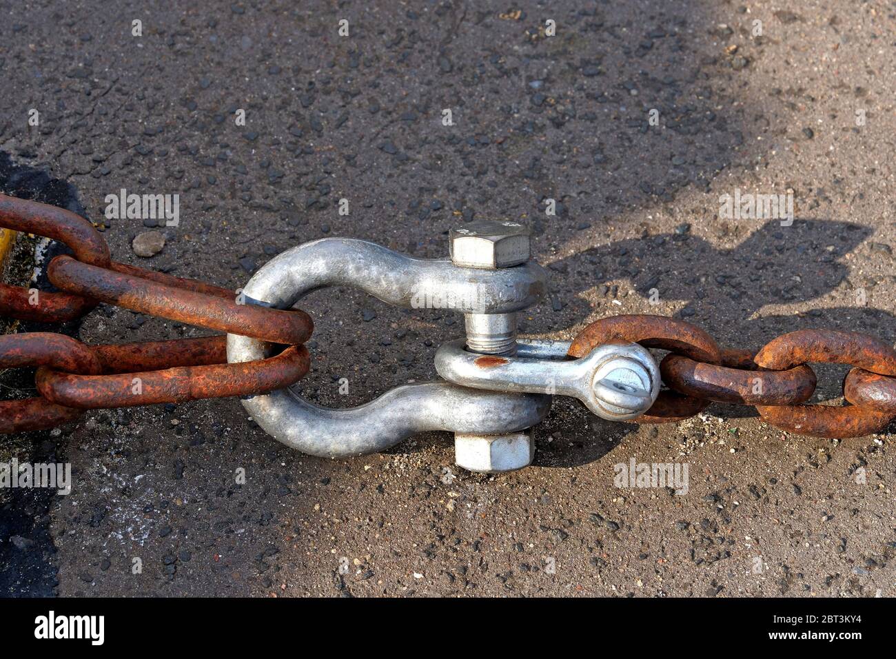 Black metal eyelet in which a shackle is fastened Stock Photo