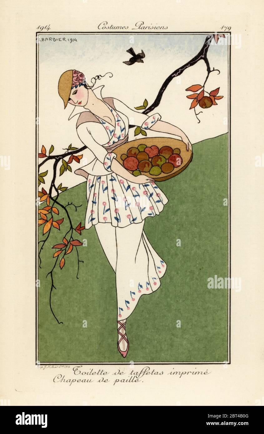 Woman with basket of autumn fruit in straw hat and dress of printed taffeta. Toilette de taffetas imprime, Chapeau de paille. Handcoloured pochoir (stencil) etching after an illustration by George Barbier from Tommaso Antonginis Journal des Dames et des Modes, Aux Bureaux du Journal des Dames, Paris, 1914. Stock Photo