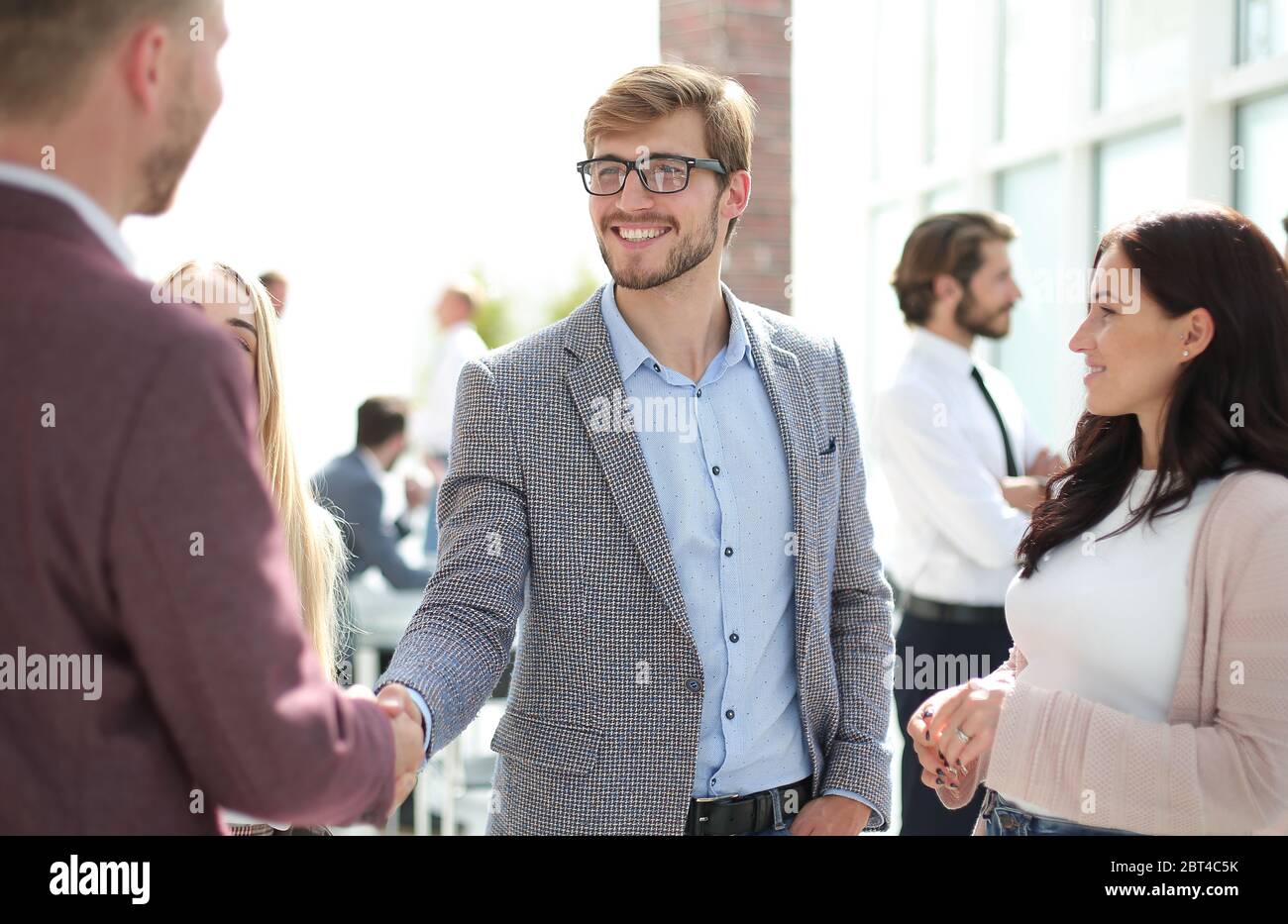 two business men shaking hands, greeting each other Stock Photo - Alamy