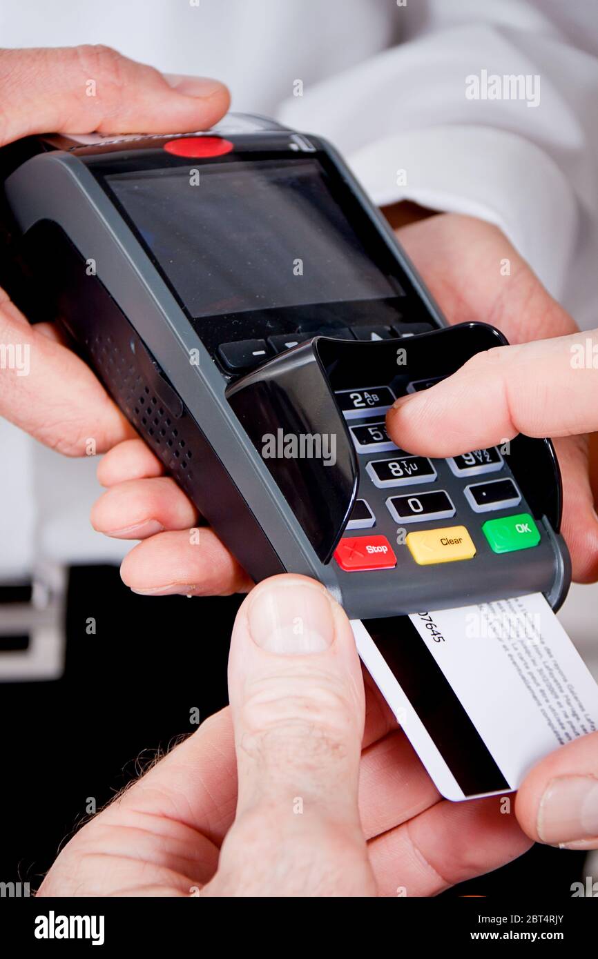 ec card payments in the restaurant with his wife and husband Stock