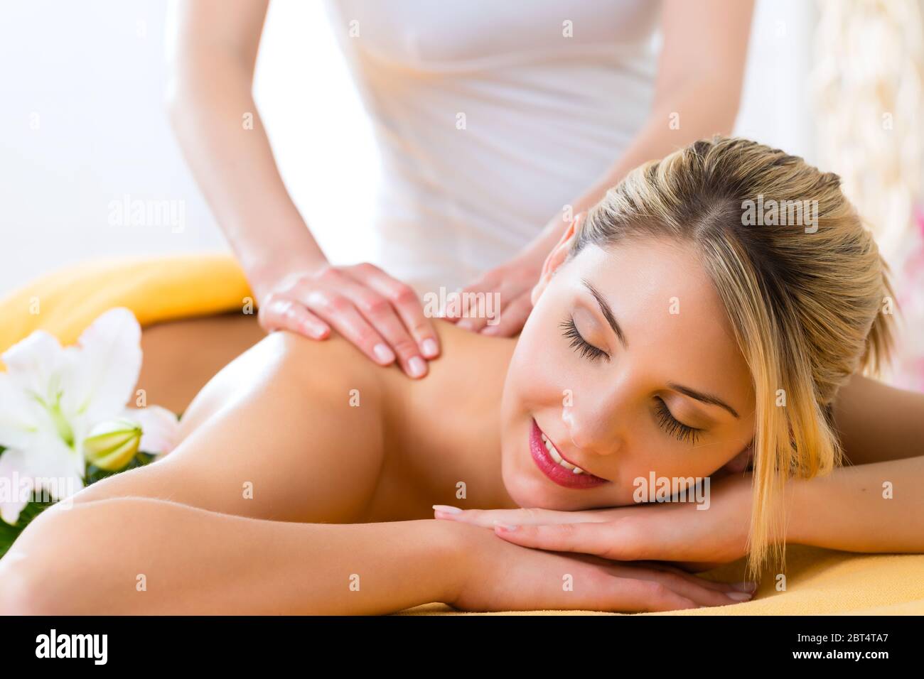 wellness - woman receiving back massage in spa Stock Photo
