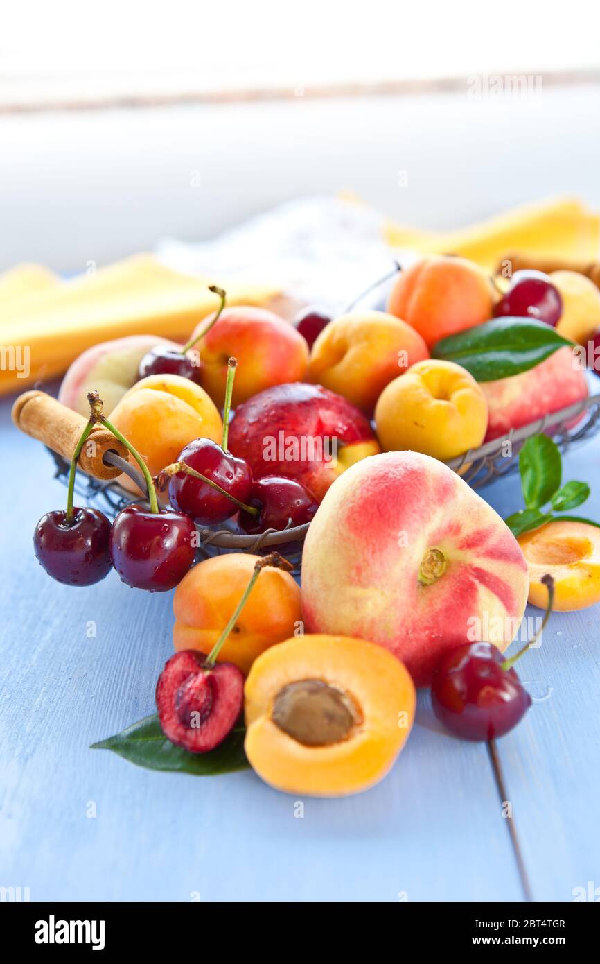 various varieties of peaches in a basket Stock Photo