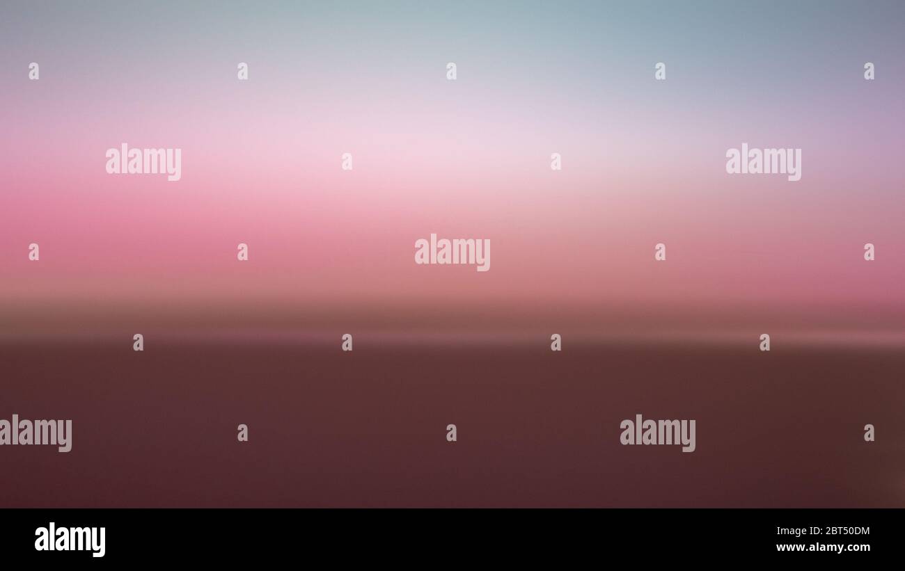Hazy background of a pink sky on a beach as an abstract background Stock Photo
