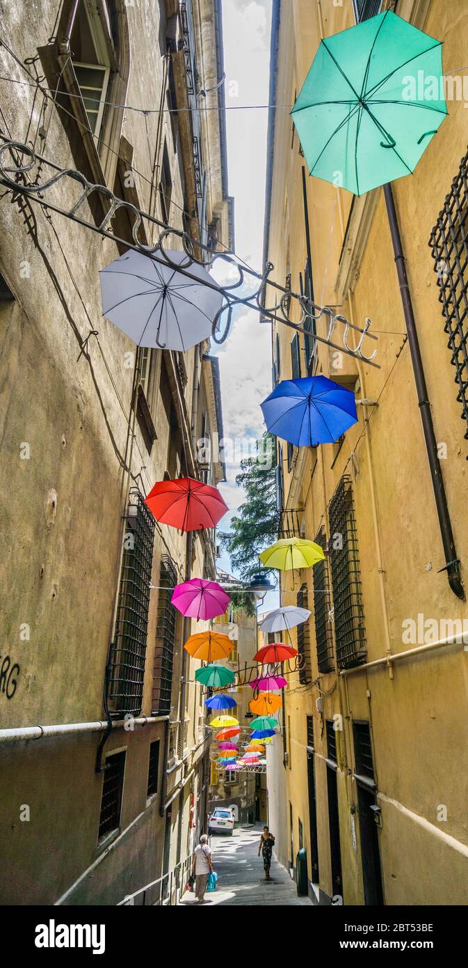 display of umbrellas and an 'emozioni' (emotions) sign at Vico del Ferro an alleyway off Via Guiseppe Garibaldi in the historic city center of Genoa, Stock Photo