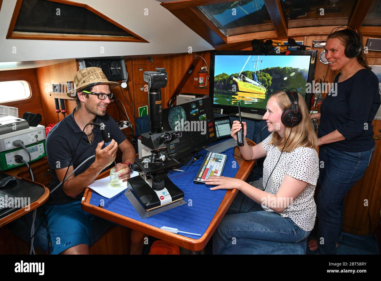 Konstanz Am Bodensee, Germany. 20th May, 2020. Aquatic ecologist Hannes  Imhof at the endoscope, Marie Beckers at the monitor and Katrin Meyer at  the mixing console from the media production department show