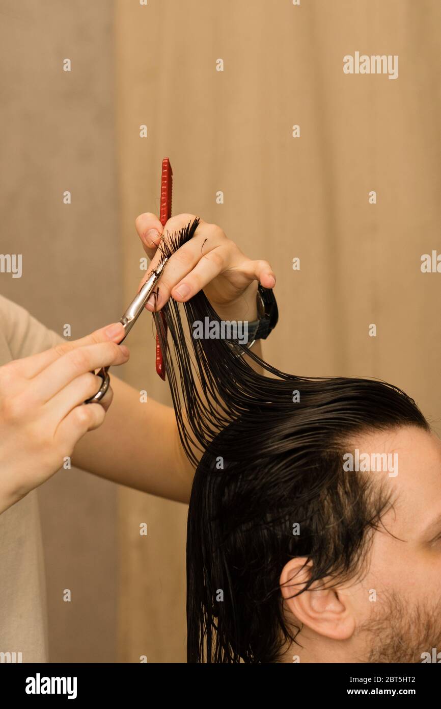 cutting male hair with scissors
