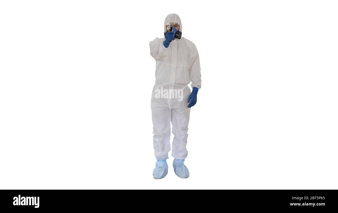Doctor in protective biohazard suit points laser thermometer to check your temperature at a covid19 checkpoint on white background. Stock Photo
