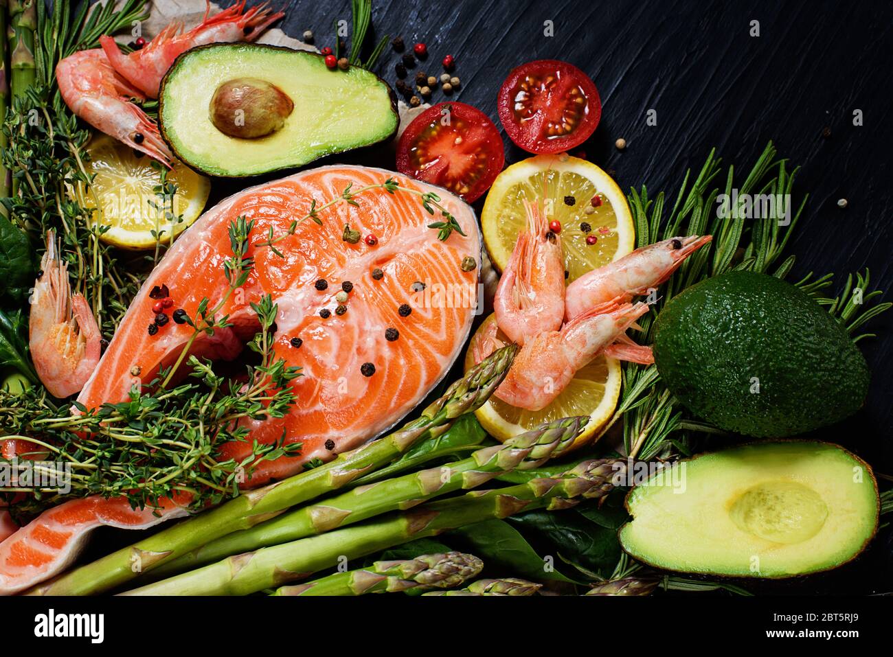 Healthy food for ketogenic diet concept on black background. Foods high