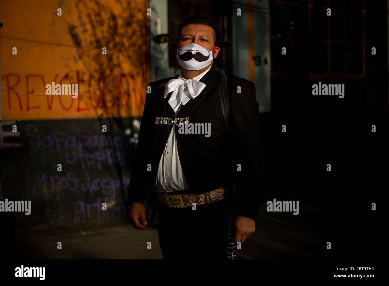 Mexiko Stadt, Mexico. 16th May, 2020. Jose Fuentes, known as 'El bigotes' (The Moustache), poses near Plaza Garibaldi and wears a mouthguard with a moustache print. Mexico's mariachis are in trouble because the anti-corona measures deprive them of their livelihood. (to dpa 'Serenade against donation: Mariachis in Mexico ask for 'rescue') Credit: Jair Cabrera Torres//dpa/Alamy Live News Stock Photo
