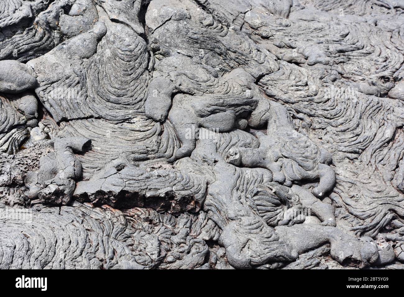 Closeup on Igneous rock dry lava with ripples and cracks Stock Photo