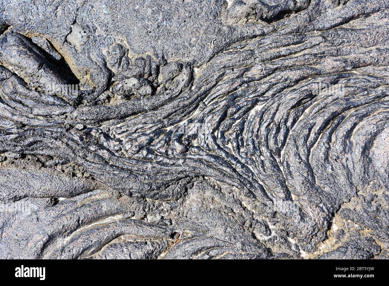 Closeup on Igneous rock dry lava with ripples and cracks Stock Photo