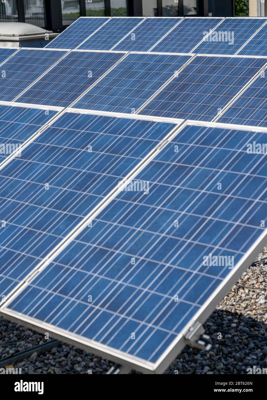 A close up view of a row of modern solar panels on a flat rooftop Stock ...