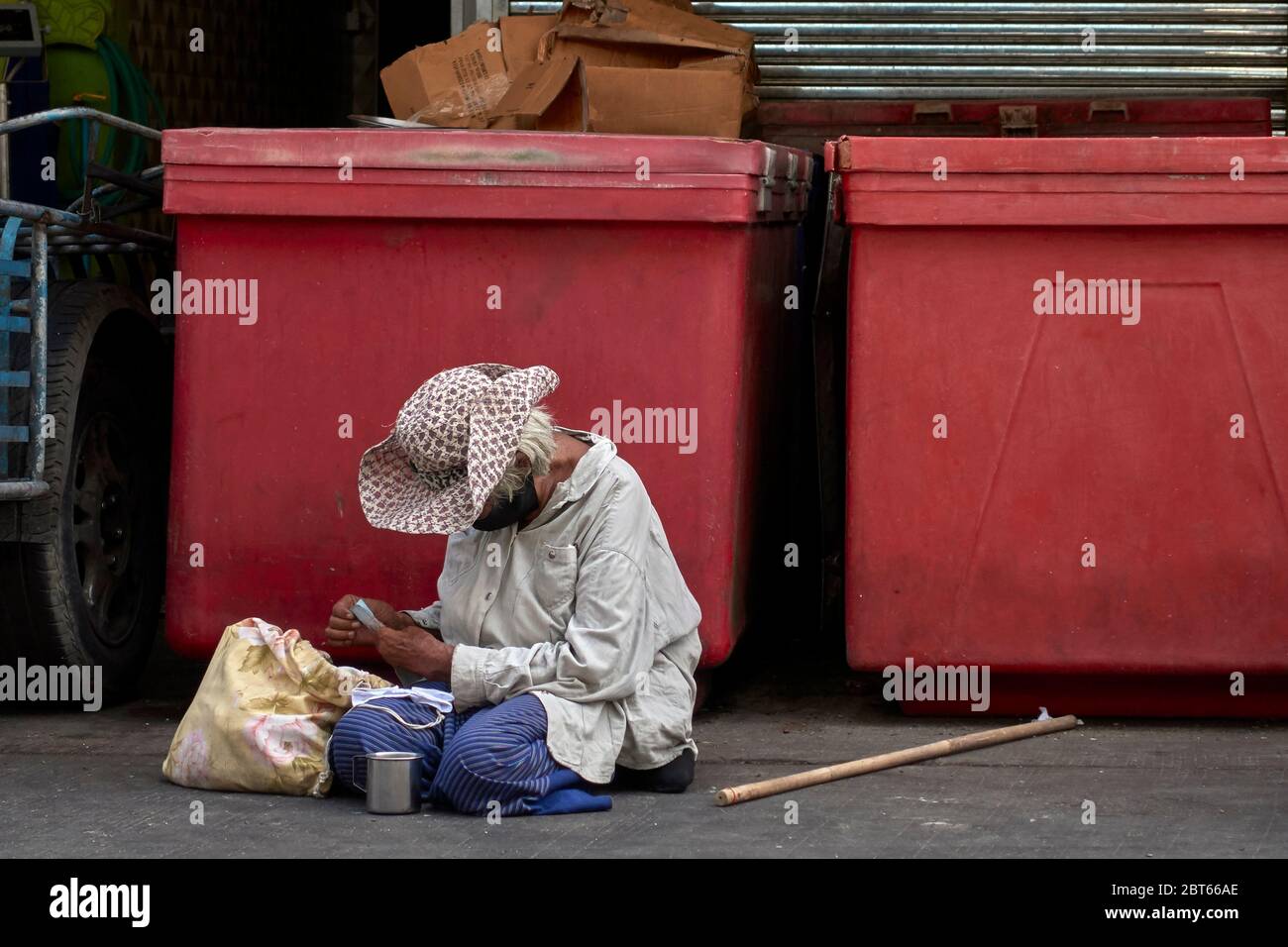 Elderly homeless woman begging on the streets of Thailand Southeast Asia Stock Photo