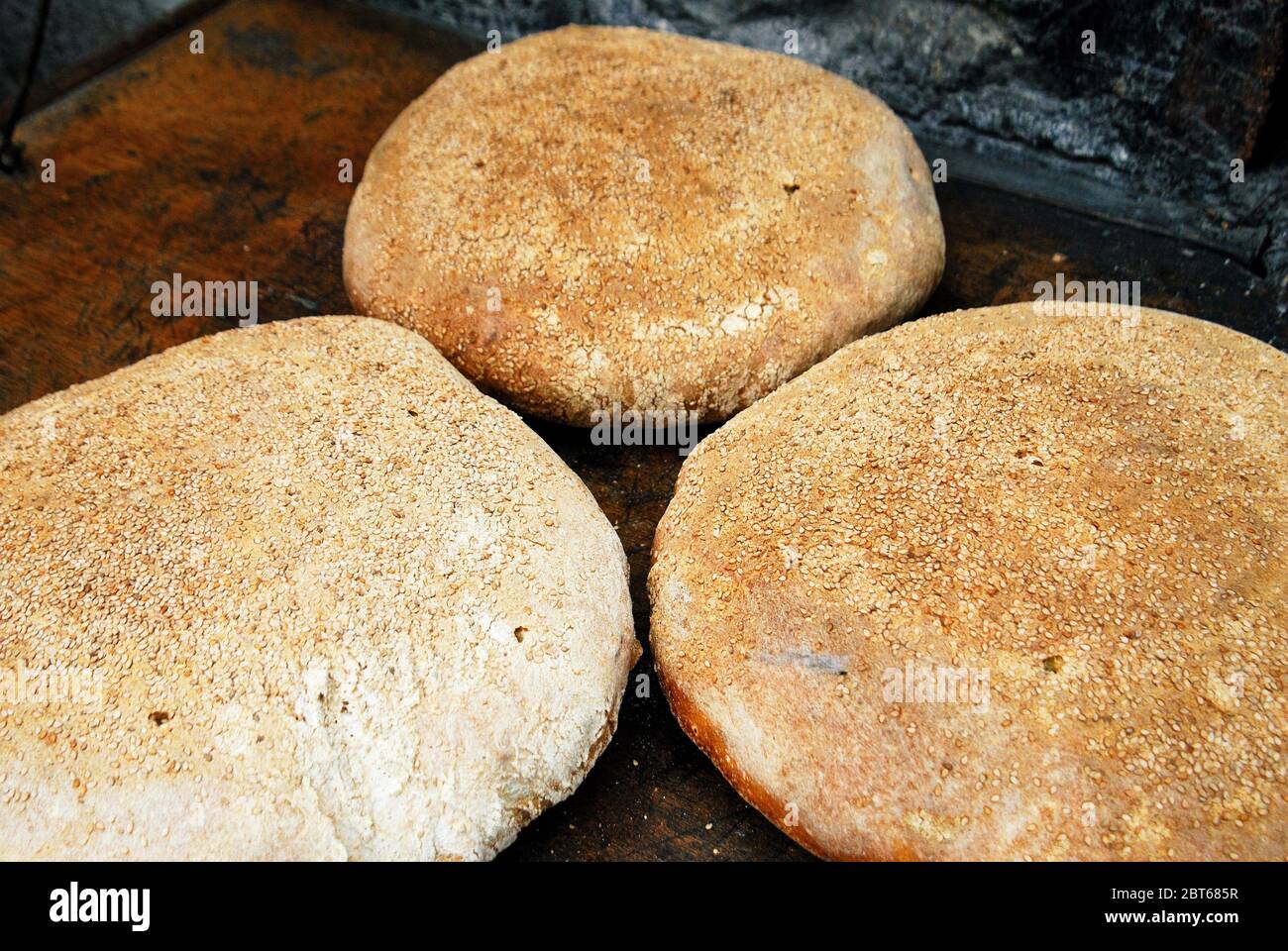 Baking special bread in traditional oven, Olympos village, Karpathos island, Greece. Stock Photo