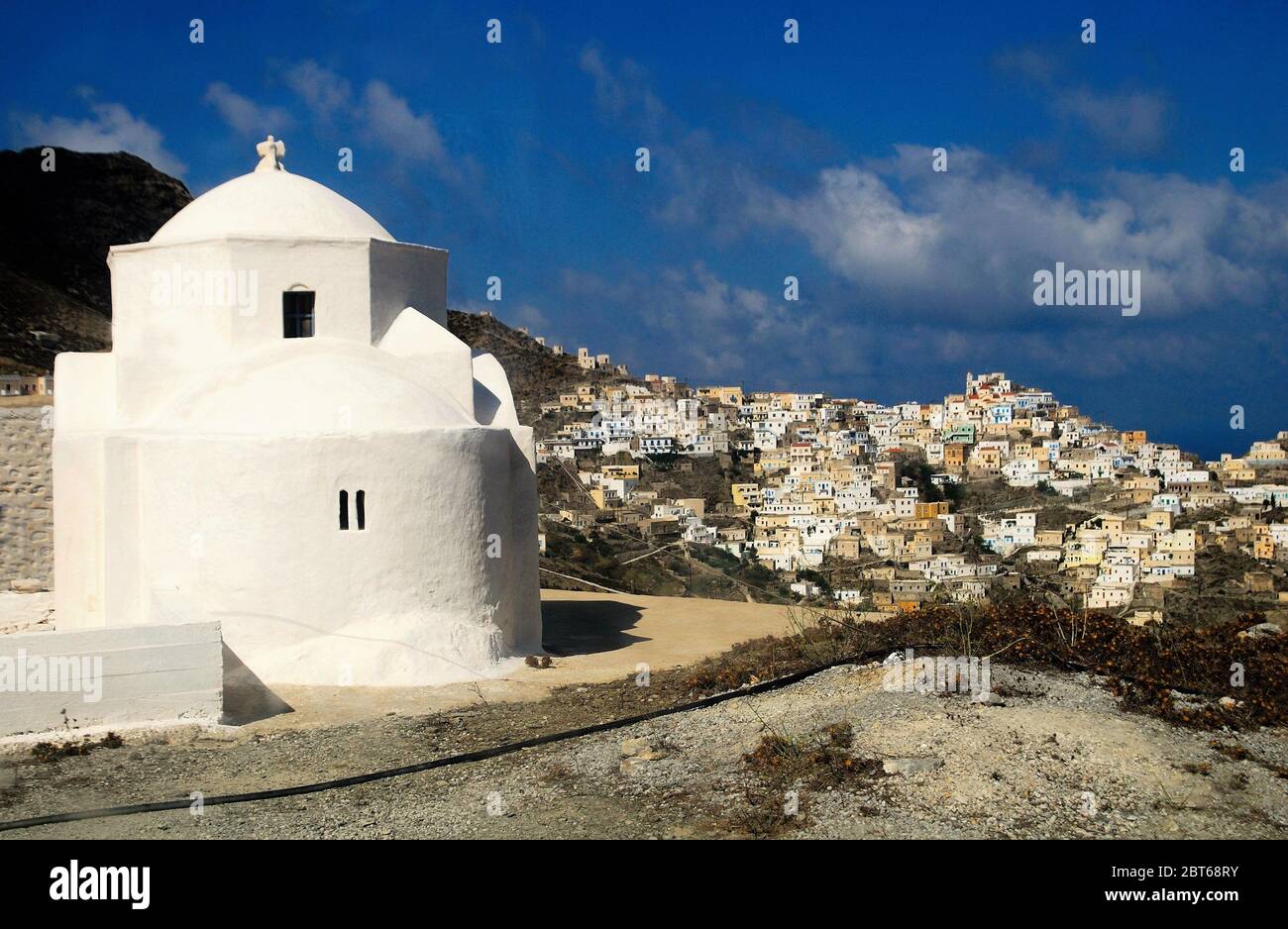 Greece, Karpathos island, Christian orthodox church with the village of Olympos in the background. Stock Photo