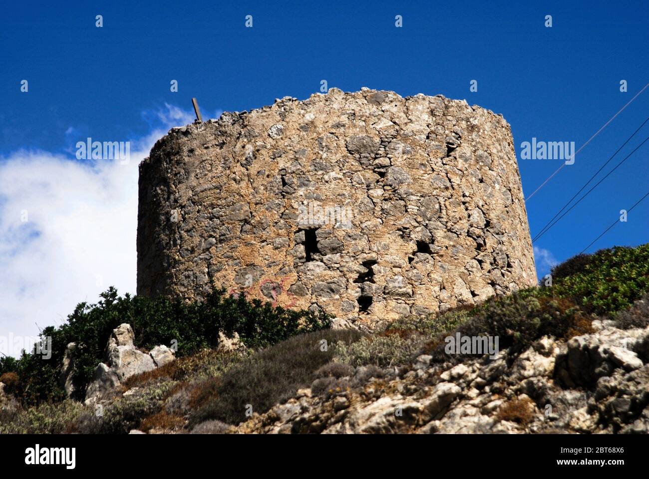 Ruins of old traditional windmill at Olympos village in Karpathos island, Greece. Stock Photo