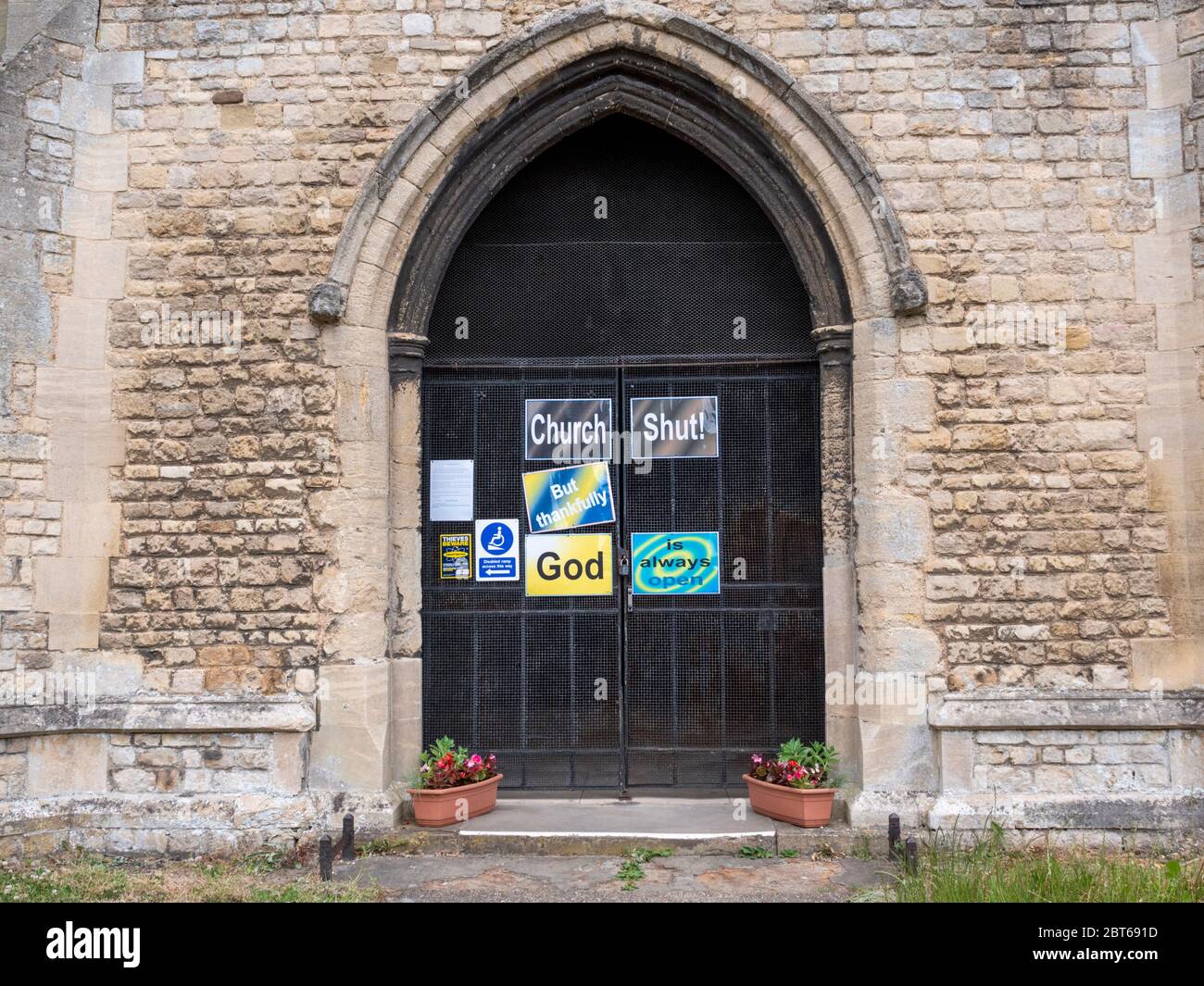 Willingham Cambridgeshire, UK. 23rd May, 2020. The church remains closed with signs on the shut door announcing that the church is closed but God is always open due to the coronavirus or covid-19 pandemic. President Trump has called for churches in USA to be reopened and they remain closed in the UK. Credit: Julian Eales/Alamy Live News Stock Photo