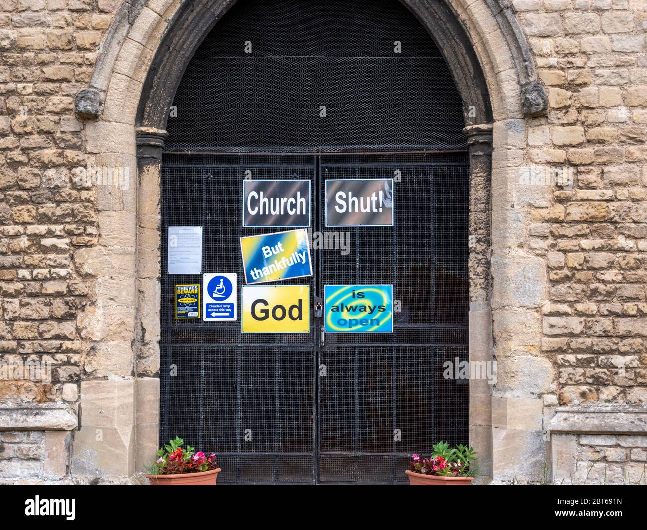 Willingham Cambridgeshire, UK. 23rd May, 2020. The church remains closed with signs on the shut door announcing that the church is closed but God is always open due to the coronavirus or covid-19 pandemic. President Trump has called for churches in USA to be reopened and they remain closed in the UK. Credit: Julian Eales/Alamy Live News Stock Photo