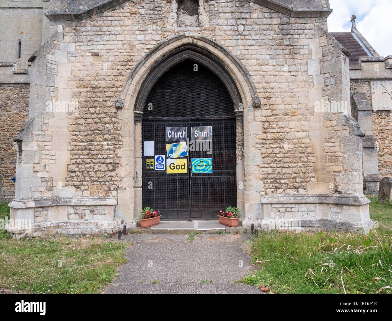 Willingham Cambridgeshire, UK. 23rd May, 2020. The church remains closed with signs on the shut door announcing that the church is closed but God is always open due to the coronavirus or covid-19 pandemic. President Trump has called for churches in USA to be reopened and they remain closed in the UK. Credit: Julian Eales/Alamy Live News Stock Photo