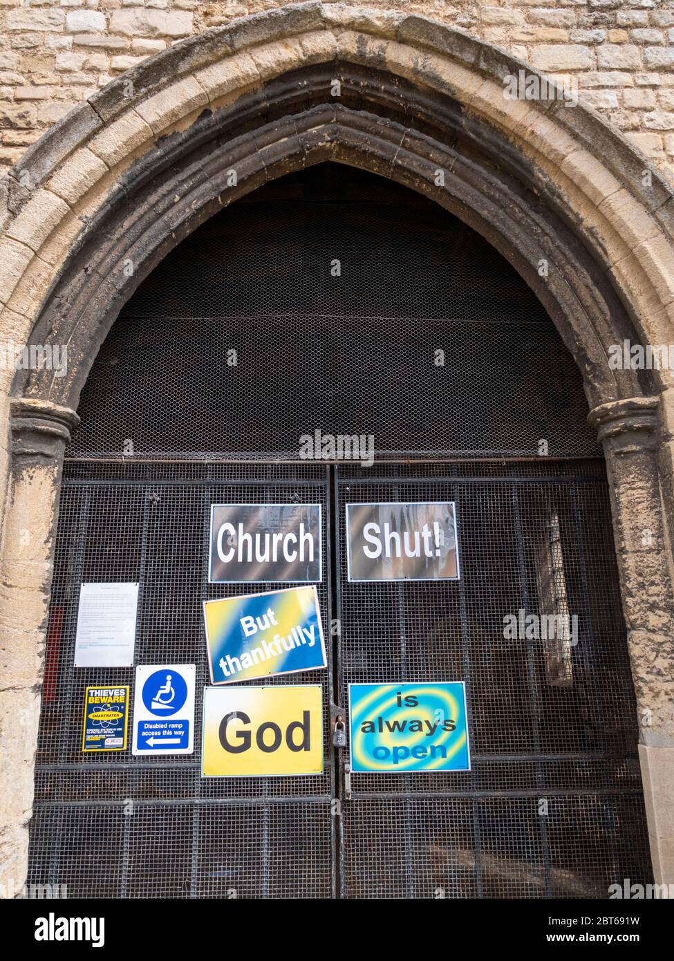 Willingham Cambridgeshire, UK. 23rd May, 2020. The church remains closed with signs on the shut door announcing that the church is closed but God is always open due to the coronavirus or covid-19 pandemic. President Trump has called for churches in USA to be reopened and they remain closed in the UK. Credit: Julian Eales/Alamy Live News Stock Photo