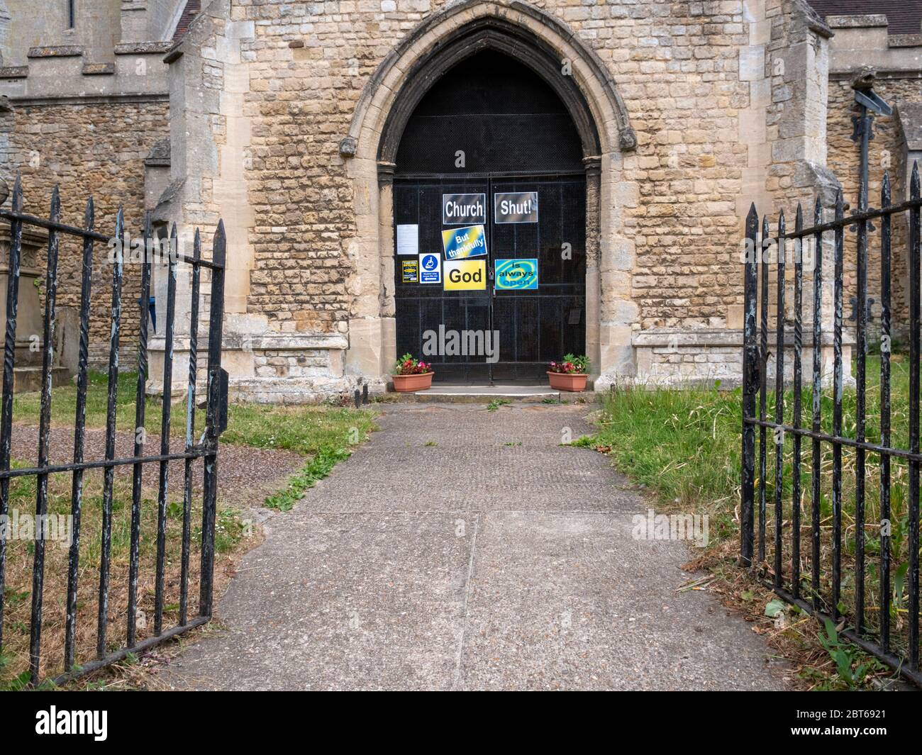 Willingham Cambridgeshire, UK. 23rd May, 2020. The church remains closed with signs on the shut door announcing that the church is closed but God is always open due to the coronavirus or covid-19 pandemic. President Trump has called for churches in USA to be reopened and they remain closed in the UK. Credit: Julian Eales/Alamy Live News Stock Photo