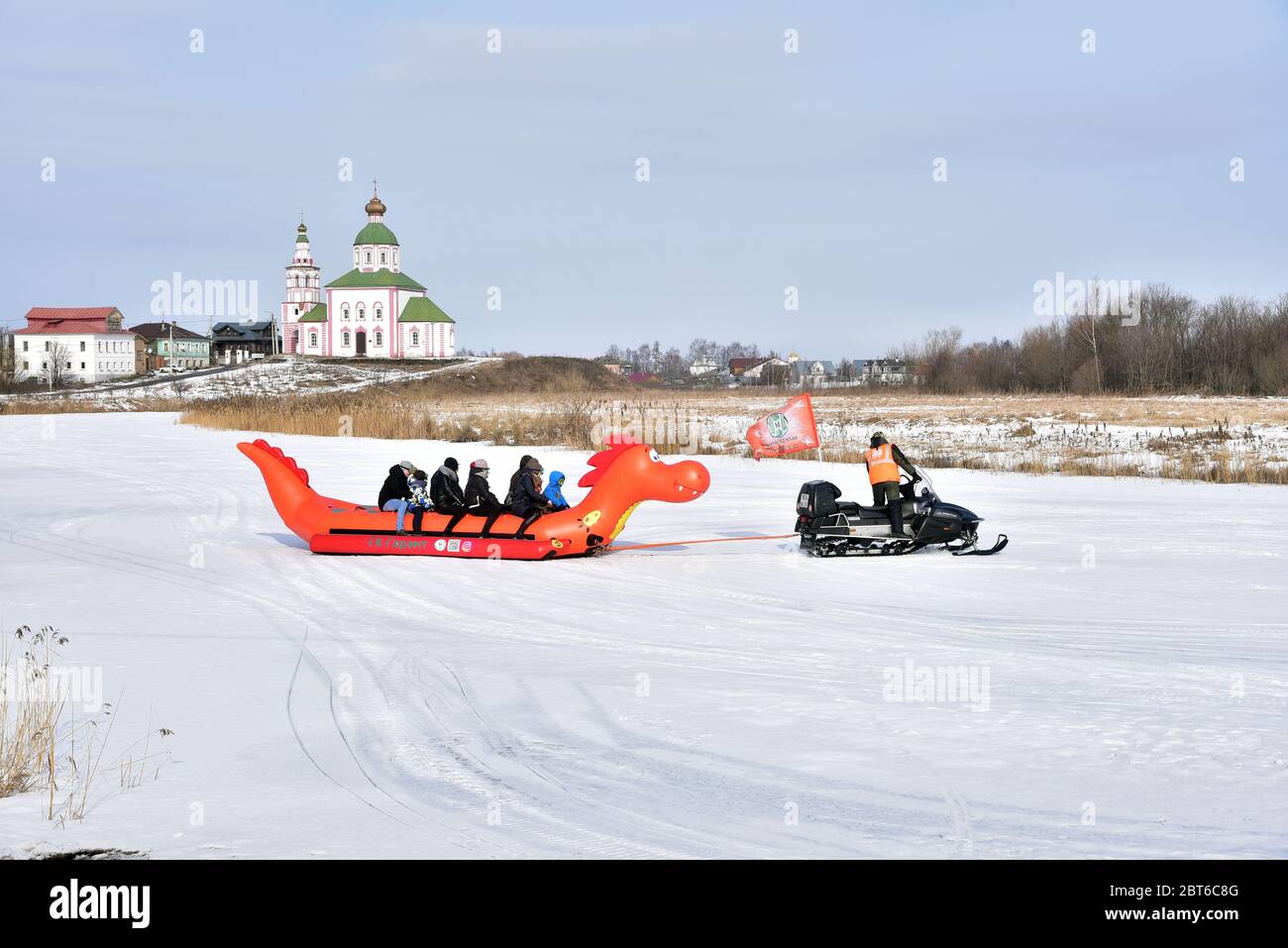 People are skiing on frozen river during Maslenitsa festival in Suzdal, Russia. Maslenitsa is an Eastern Slavic religious and folk holiday, Stock Photo