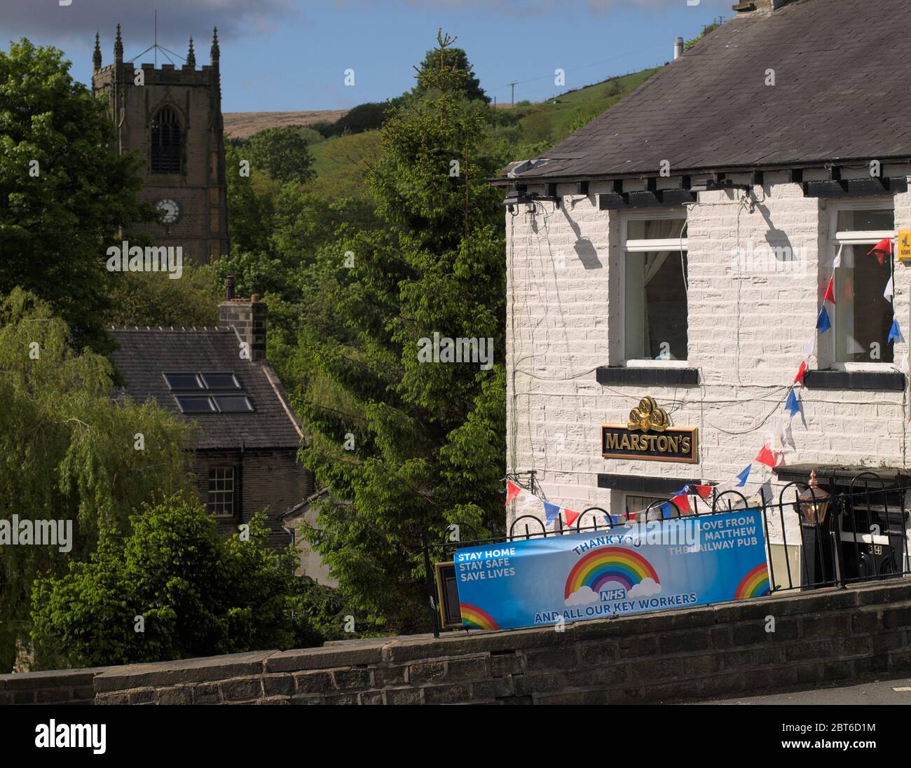 The Railway pub, Marsden with both 'TO LET' and 'NHS / KEY WORKER THANK YOU' signs during the Coronavirus (COVID-19) pandemic. Stock Photo