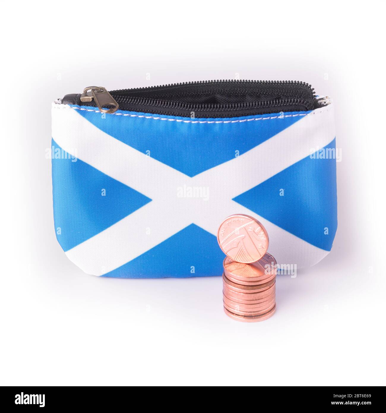 Open Scottish Saltire flag purse with pile of British sterling penny coins on a white background Stock Photo