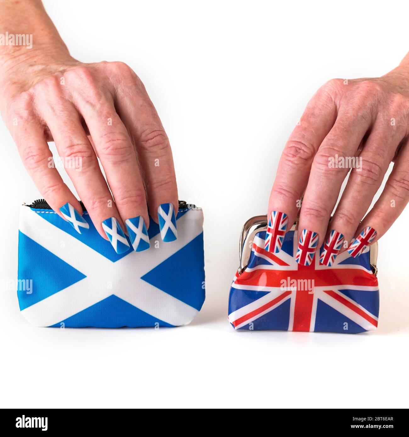 Hands wearing Saltire and Union flag false nails Stock Photo