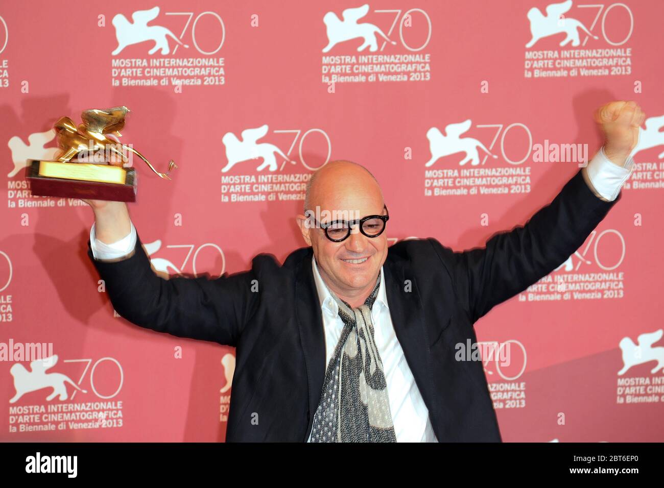 VENICE, ITALY - SEPTEMBER 07: Gianfranco Rosi poses with the Golden Lion award for the Best Film for 'Sacro Gra' at the Award Winners Photocall Stock Photo