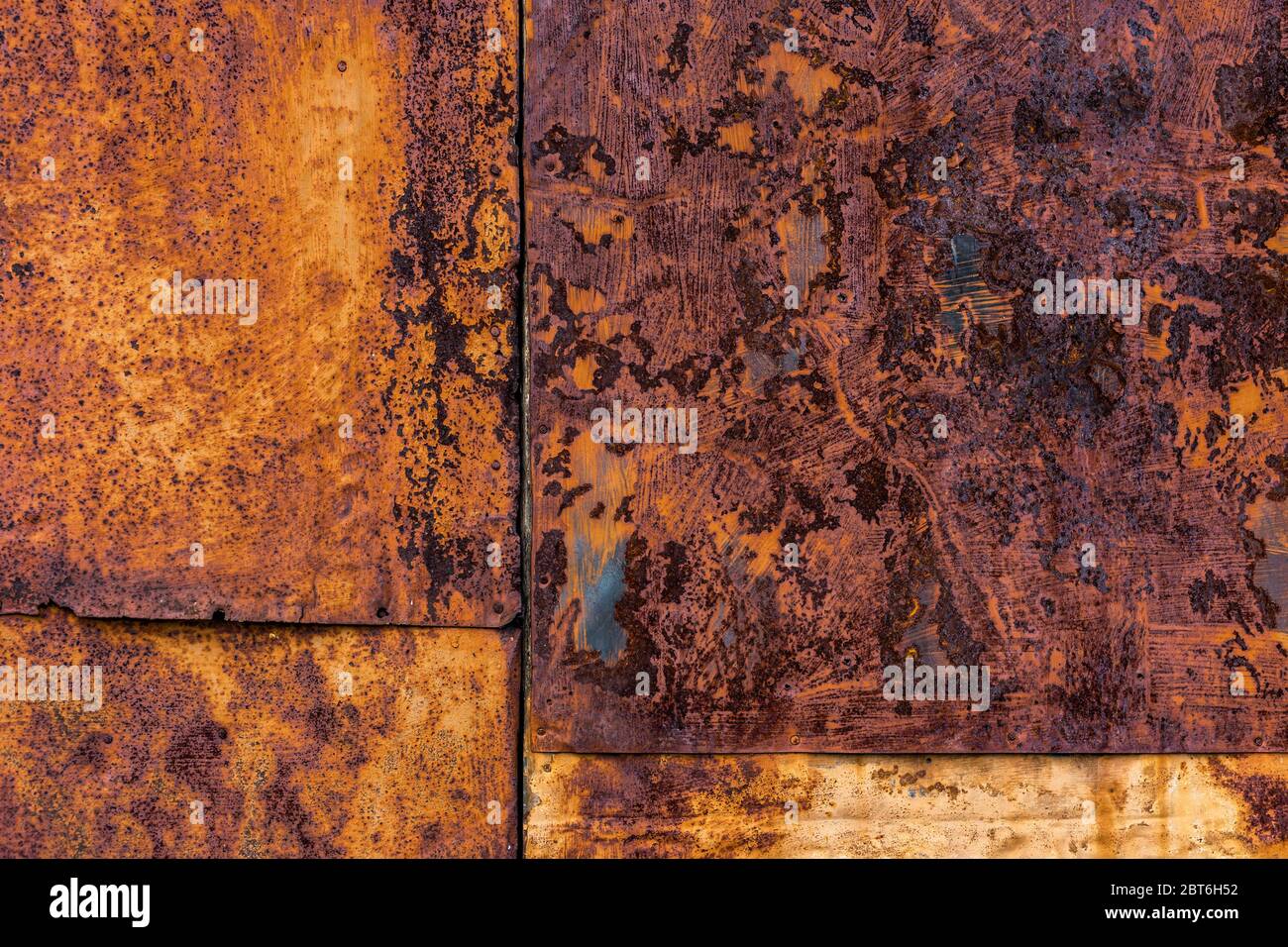 Rusted flat composite nailed metal sheets surface background and texture. Stock Photo